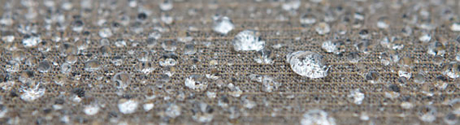 close up detail view of water droplets on hydrophobic fabric