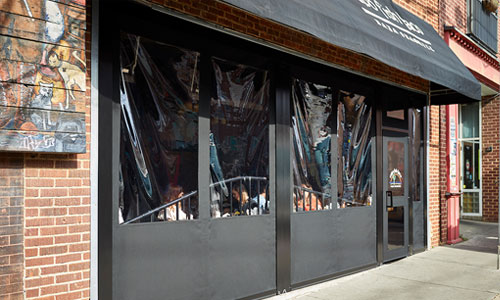 a black fabric awning elegantly installed in front of a building